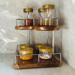 Wood Ceylon corner spice rack with two wooden shelves and metal frame holding jars of spices