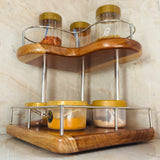Wood Ceylon corner spice rack with two-tier wooden shelves and metal railing holding spice jars