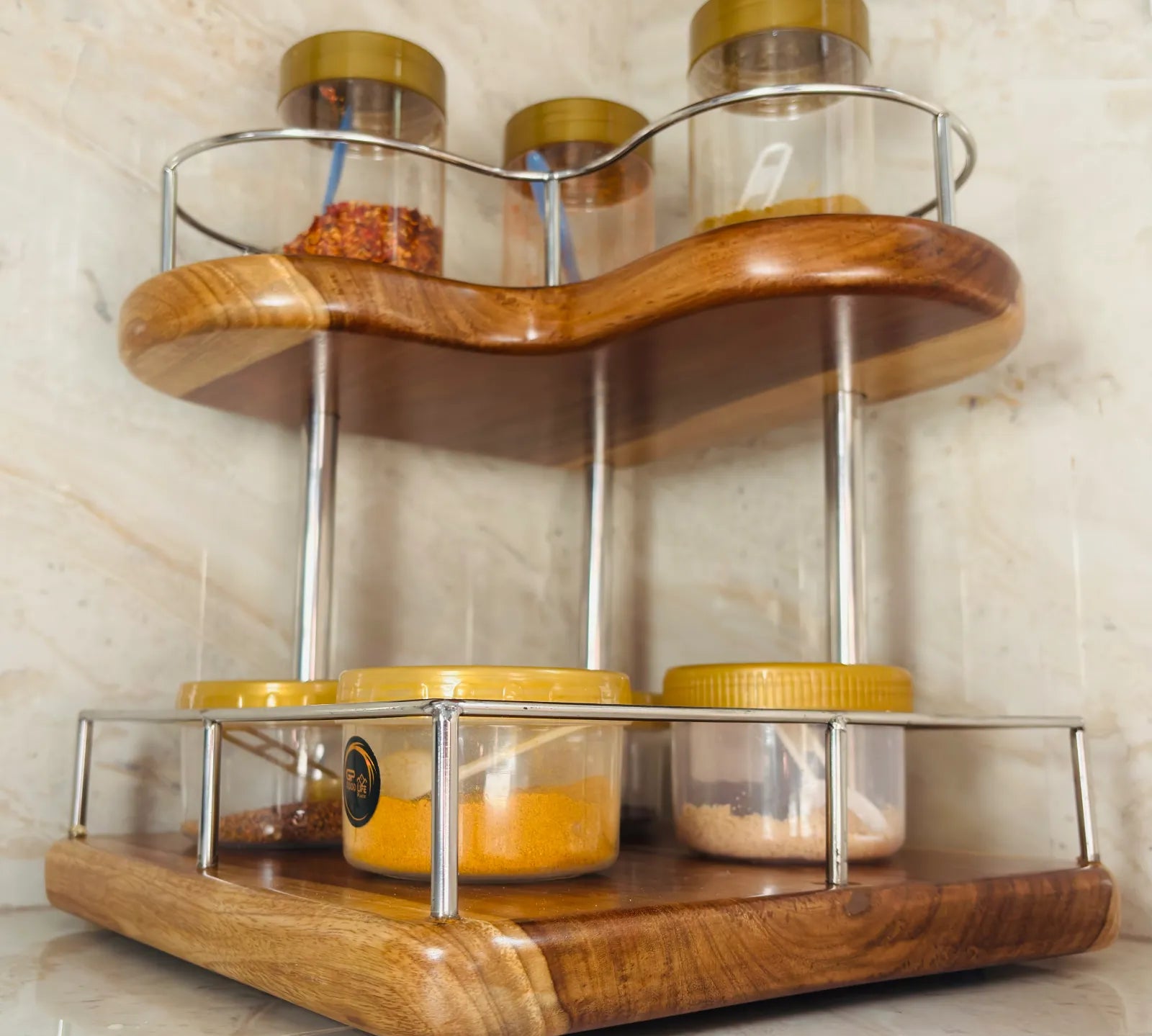 Wood Ceylon corner spice rack with two-tier wooden shelves and metal railing holding spice jars