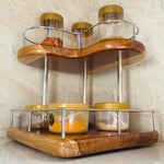 Wood Ceylon corner spice rack with two-tier wooden shelves and metal railing holding spice jars