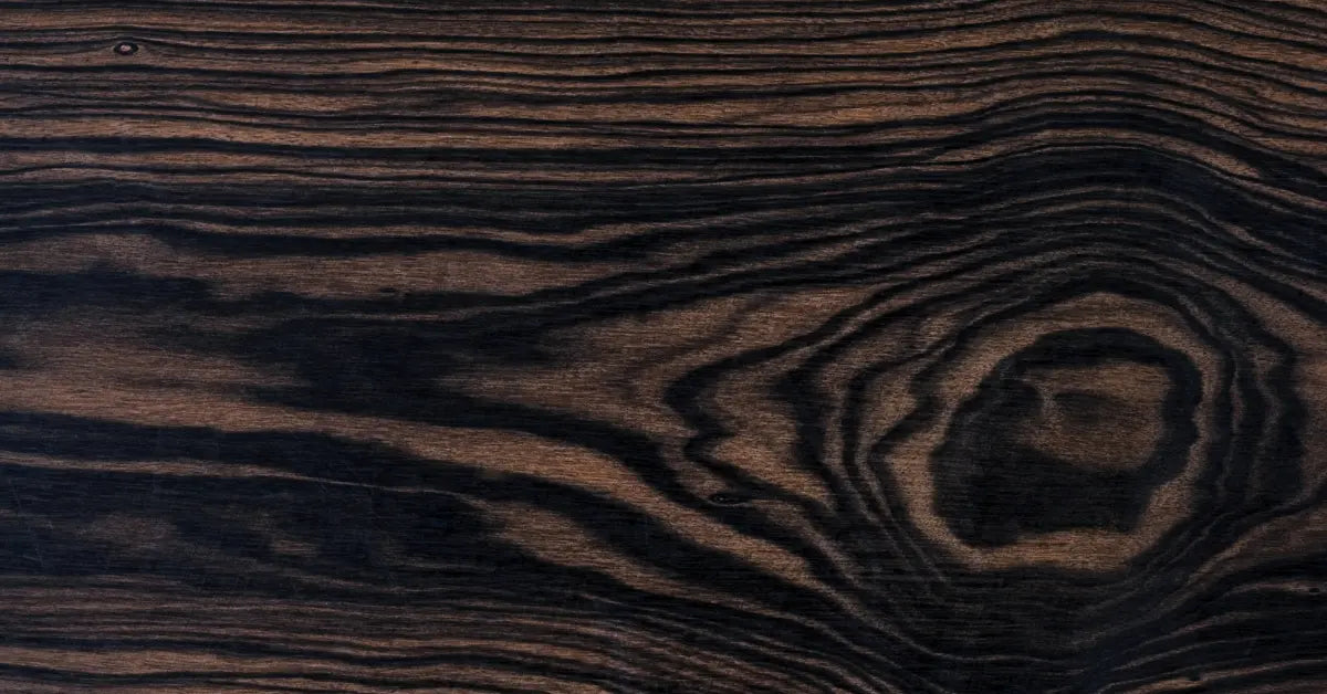 Close-up of dark wood surface showing unique wood grain textures and natural patterns