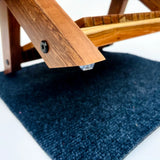 Close-up of Wood Ceylon small dish drying rack wooden leg with protective rubber foot on dark mat