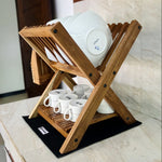 Wood Ceylon small dish drying rack made of wood holding white plates and cups on kitchen counter