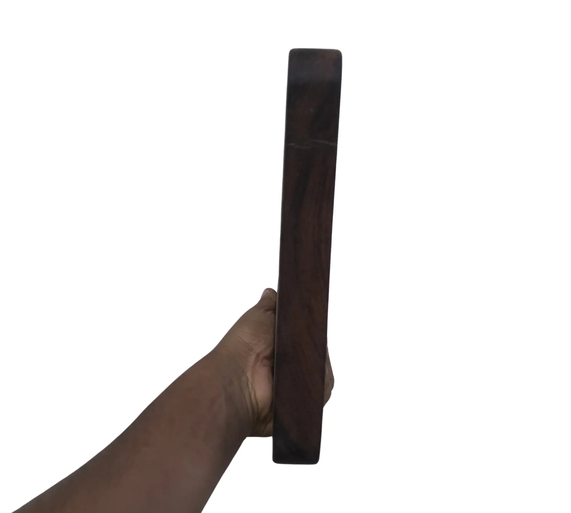 Hand holding a thick dark wood cutting board by Wood Ceylon showing side profile