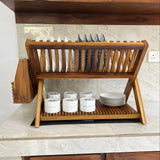 Wood Ceylon wooden dish drying rack with slots for plates and cups on kitchen countertop