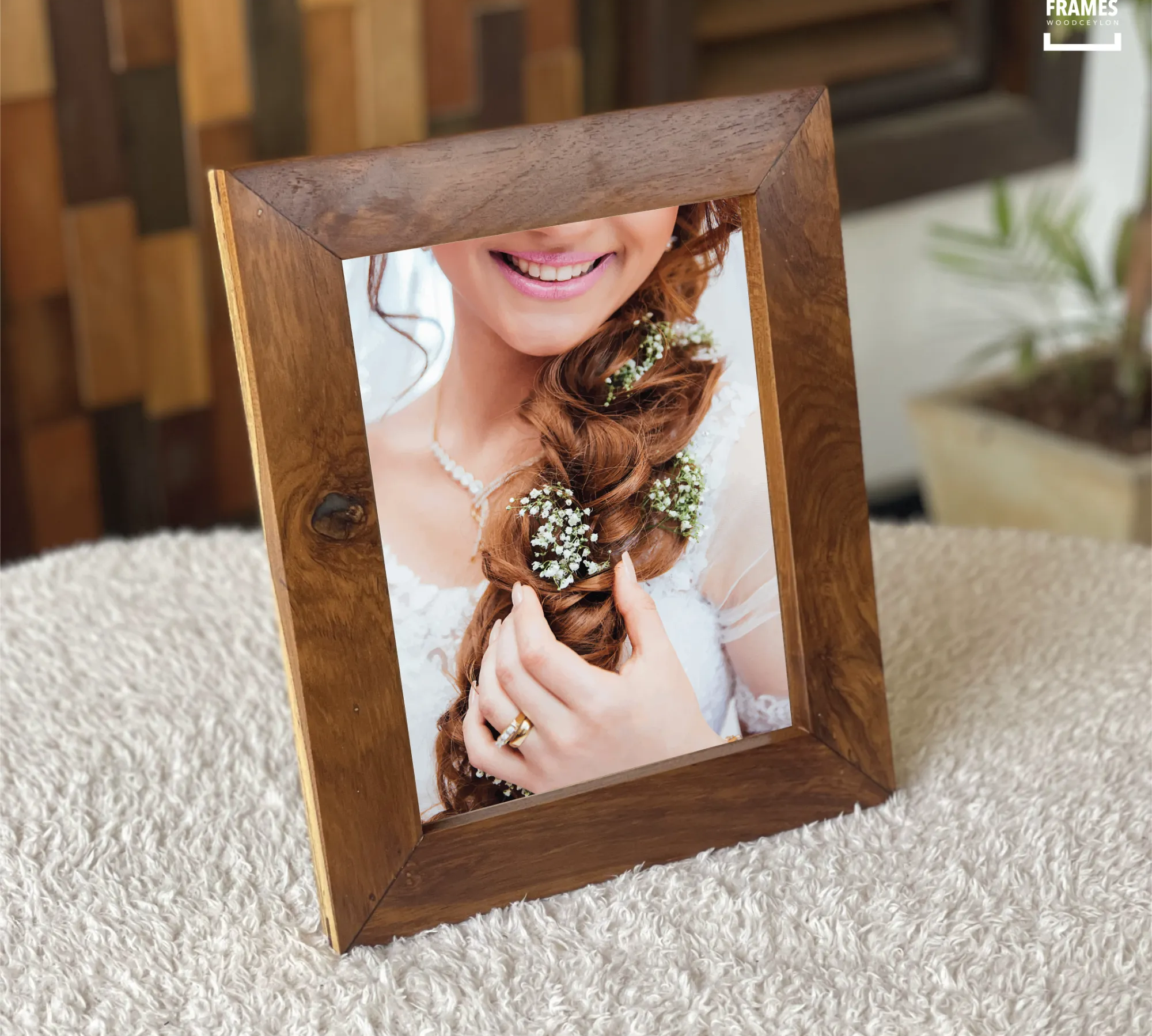 Wooden picture frame by Wood Ceylon showcasing a rustic dark wood finish on a textured surface