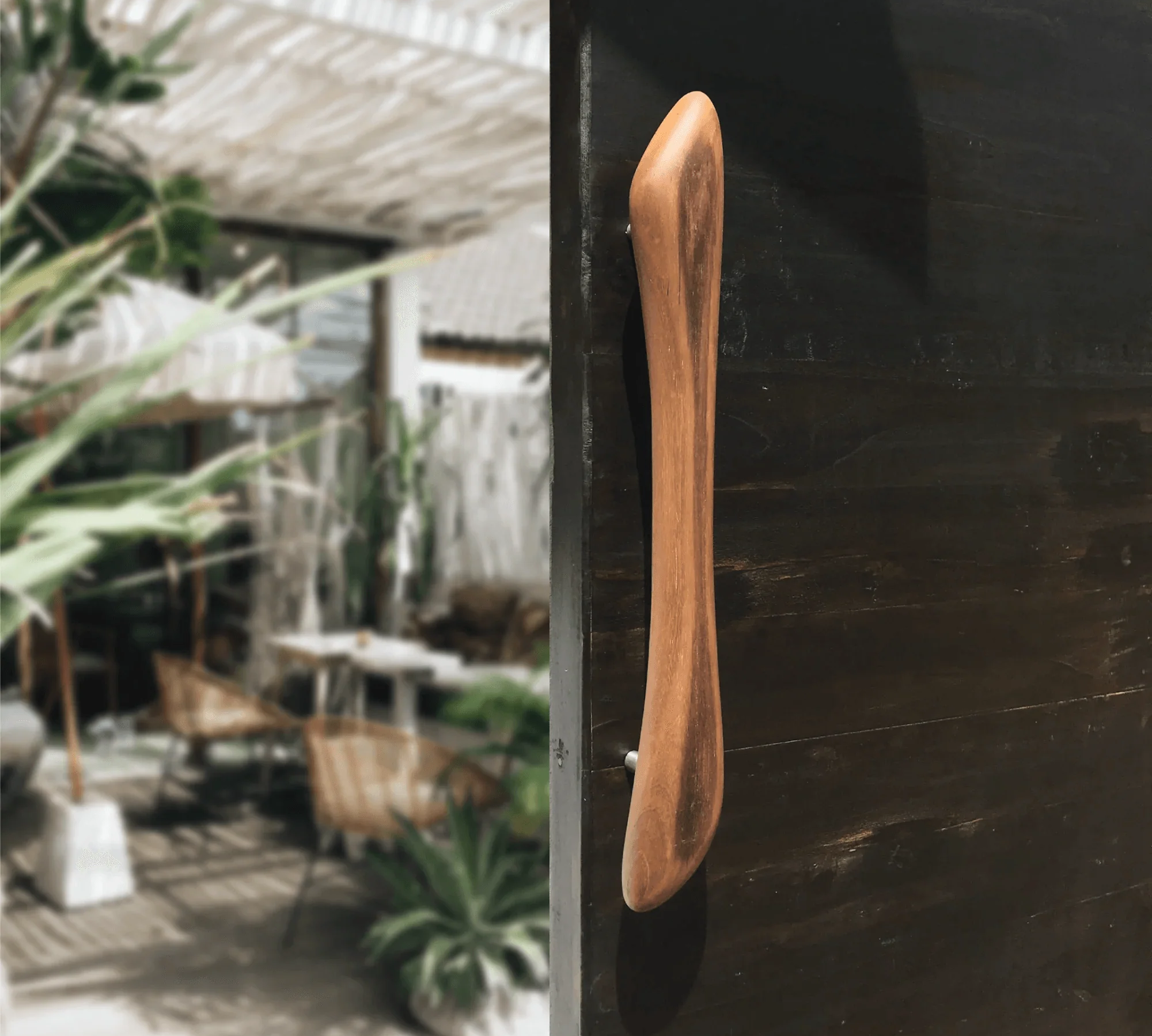 Wooden front door handle by Wood Ceylon mounted on a dark wooden door in a modern outdoor setting